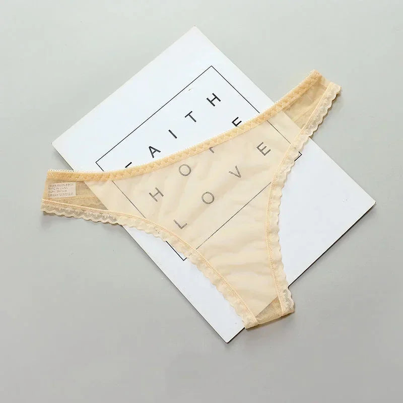 Beige lace thong on a white card with 'FAITH HOME LOVE' text on a gray background