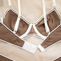 Brown ribbed bra and panties set with white straps on a beige background