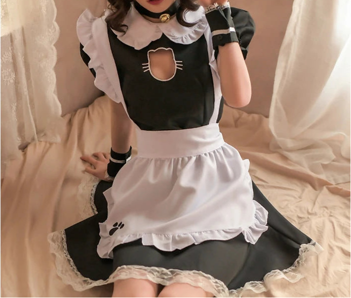 Person wearing a black and white maid outfit with a cat design.