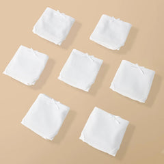 White square cloths arranged on a beige background