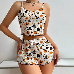 Two-piece Halloween-themed outfit with pumpkins, cats, and witch hats on a white background.