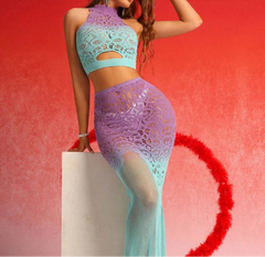 Woman wearing a colorful lace outfit against a red background