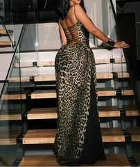 Woman in a leopard print dress standing on a staircase