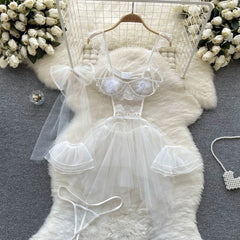 White lace lingerie set on a fur rug with decorative elements