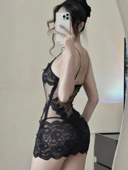 Person wearing a black lace lingerie set taking a mirror selfie.