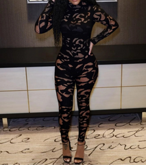 Person wearing a black lace outfit in an indoor setting