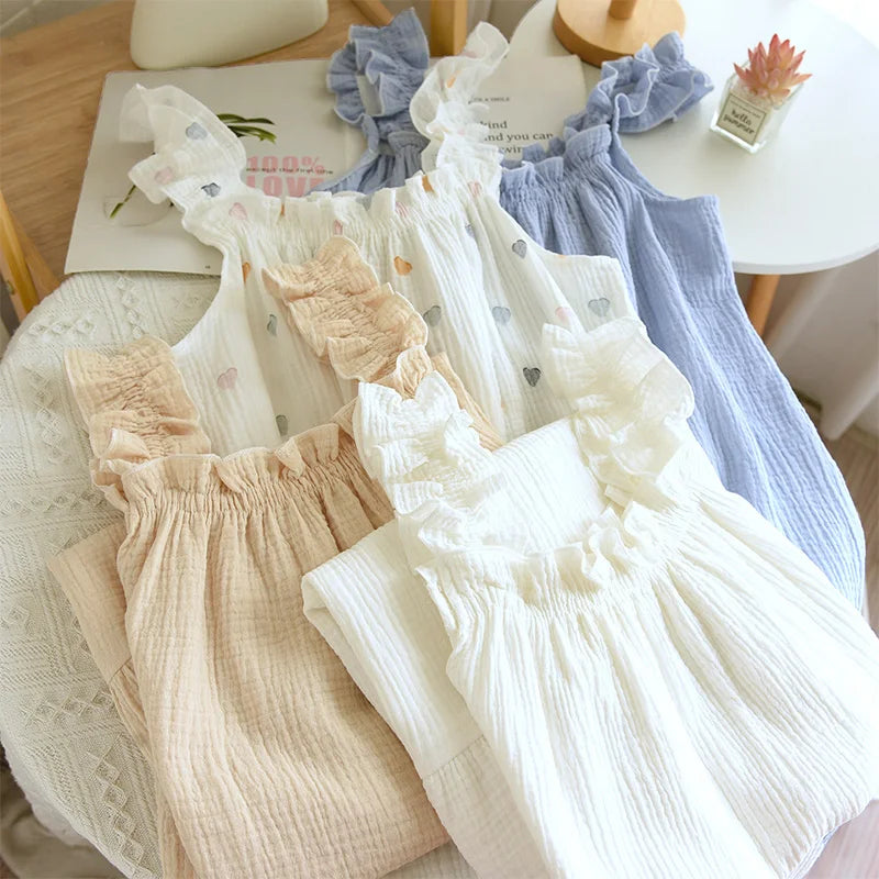 Set of baby rompers in various colors on a table.