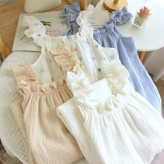 Set of baby rompers in various colors on a table.