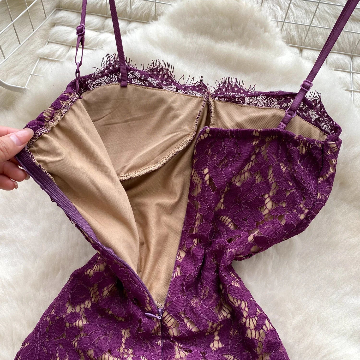 Purple lace lingerie set on a white surface