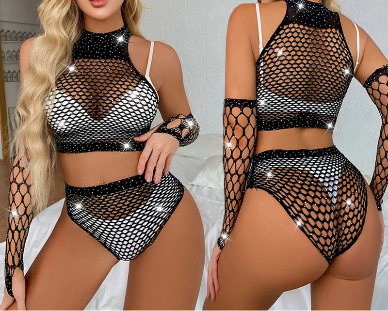 Woman wearing a black fishnet outfit with sparkles in a bedroom setting