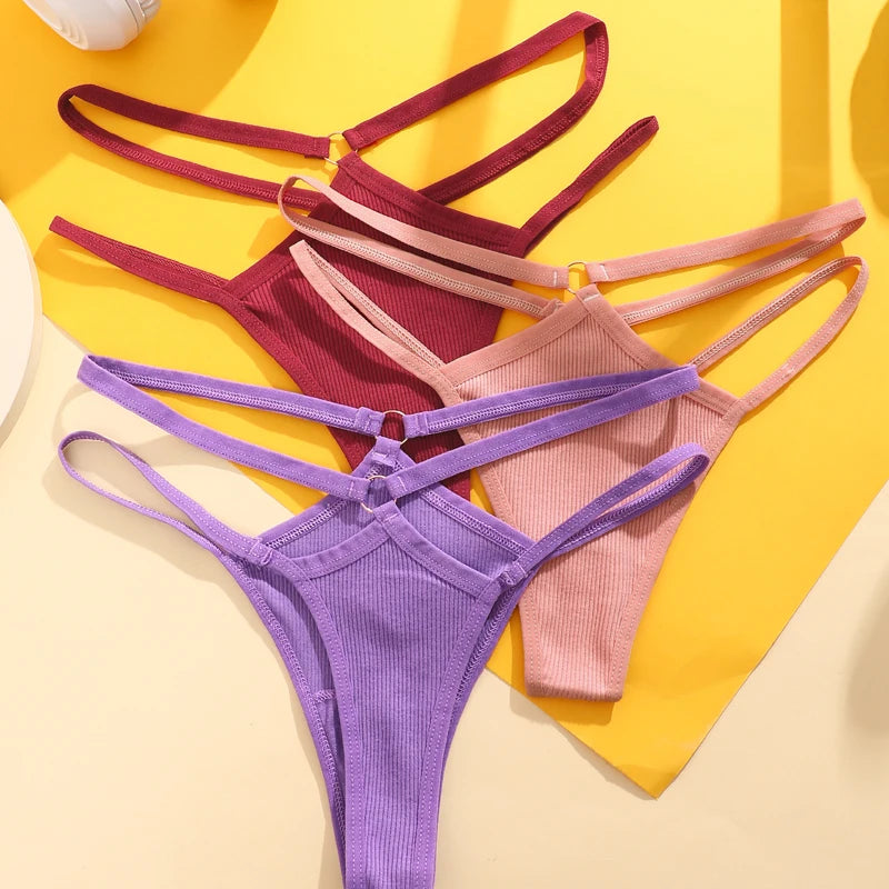 Three pairs of colorful thongs on a yellow and beige background