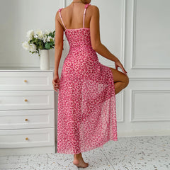 Woman wearing a pink floral dress in a room with white walls and furniture.