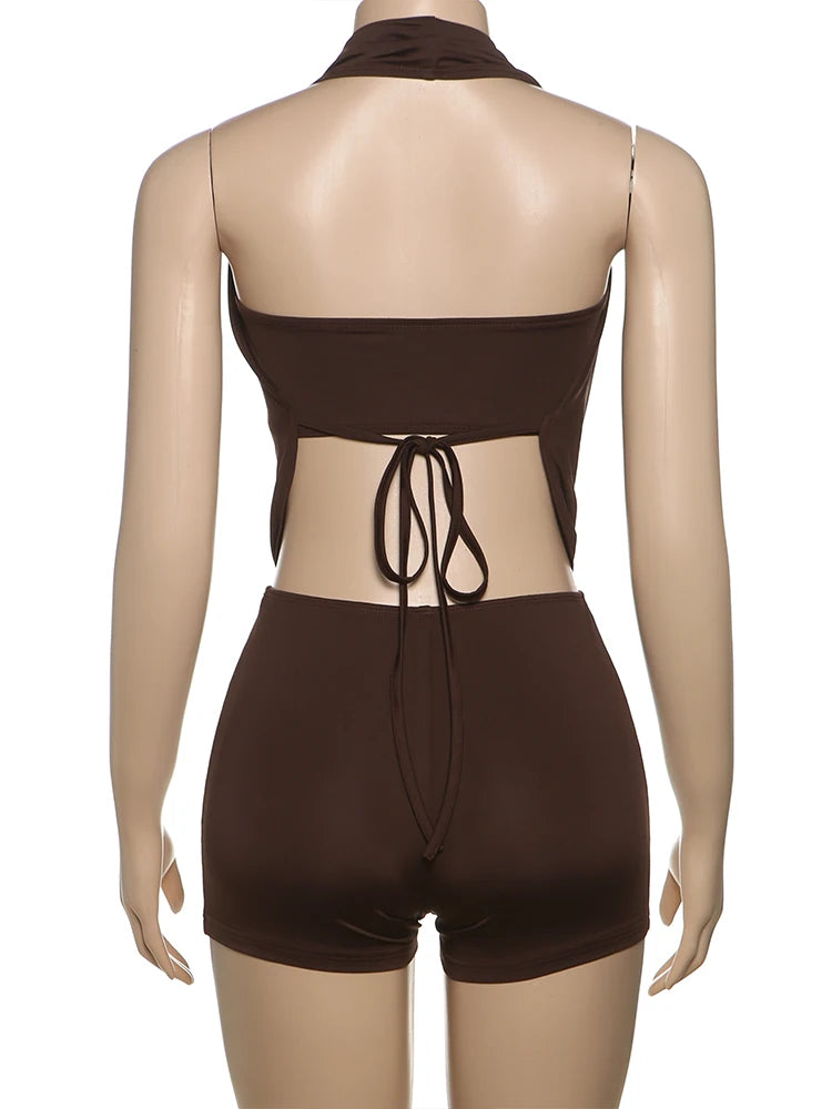 Brown swimsuit with open back on a mannequin against a white background