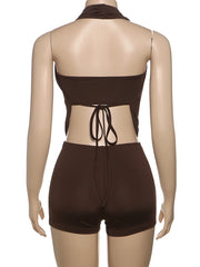 Brown swimsuit with open back on a mannequin against a white background