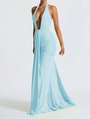 Woman wearing a light blue evening gown with a plunging neckline on a white background