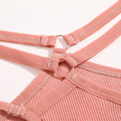 Close-up of a pink garment with straps on a white background
