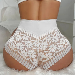 White lace shorts worn by a person on a neutral background