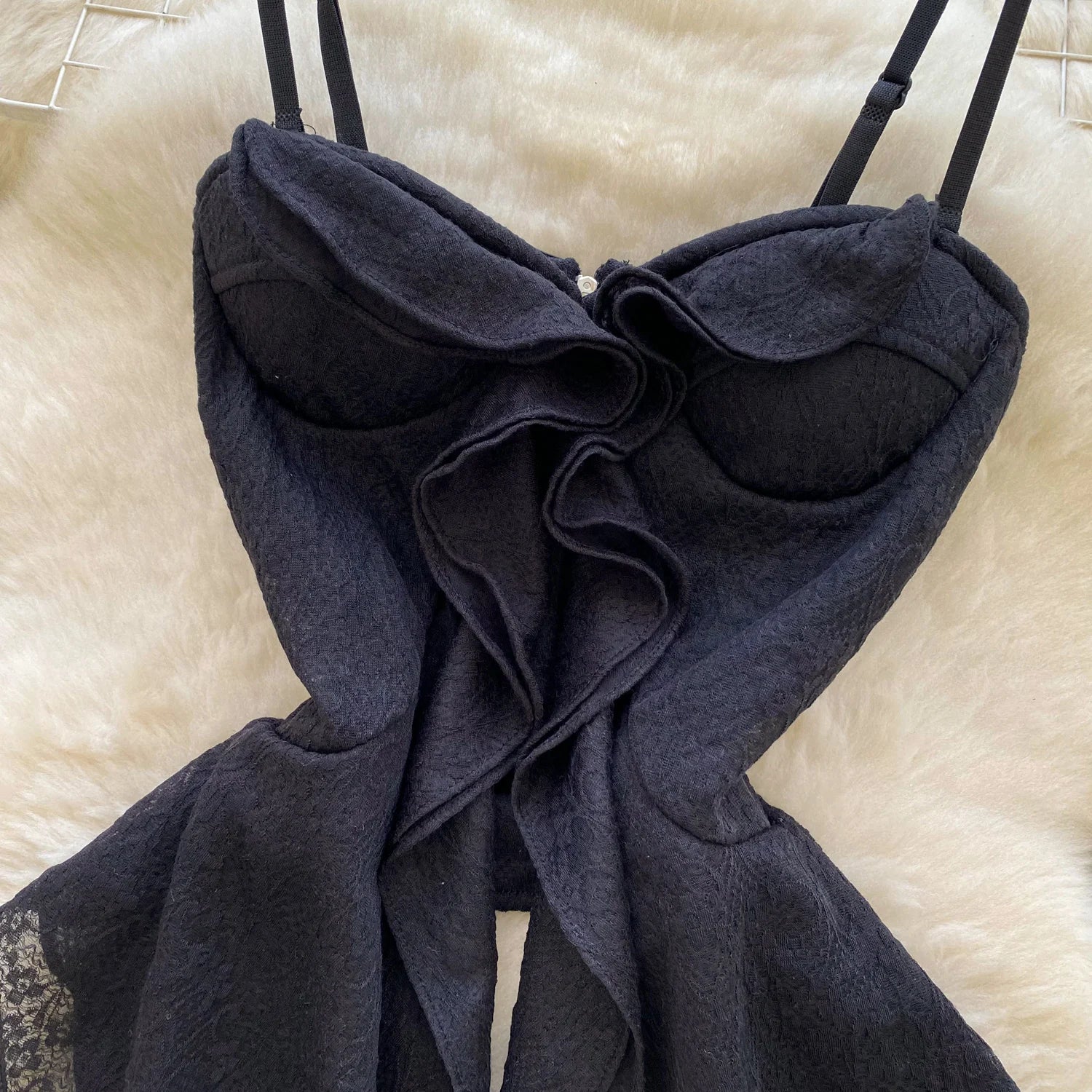 Black lace lingerie set on a beige surface