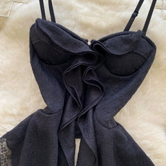 Black lace lingerie set on a beige surface