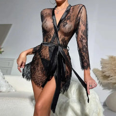 Person wearing a black lace robe in a neutral setting