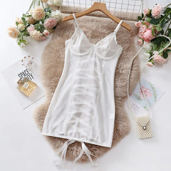 White camisole on a wooden hanger with flowers and a fur rug in the background