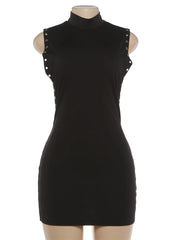 Black dress with studded details on a mannequin against a white background