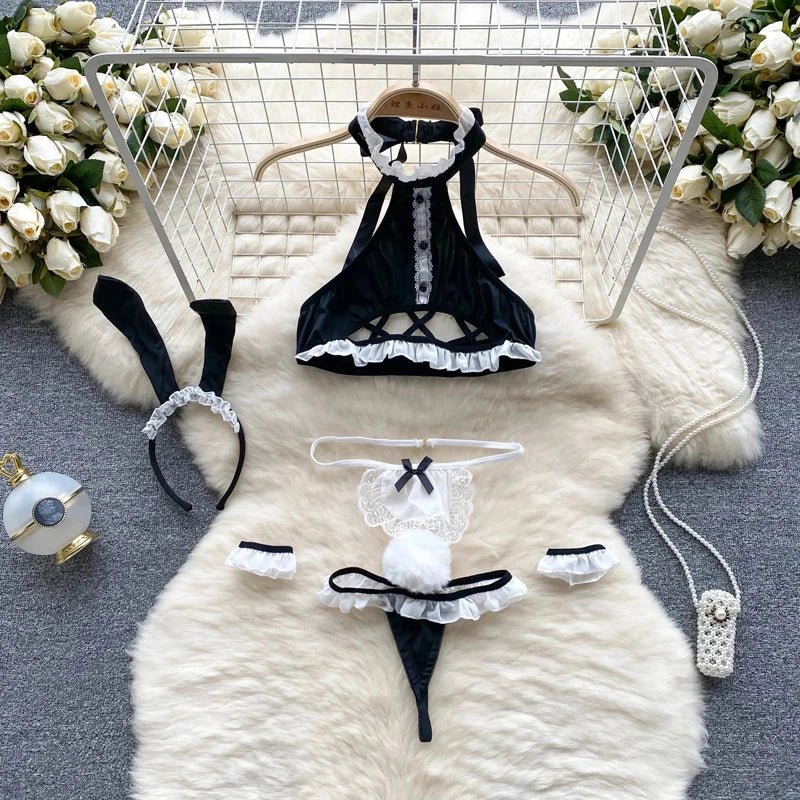 Black and white maid costume set on a fur rug with flowers in the background