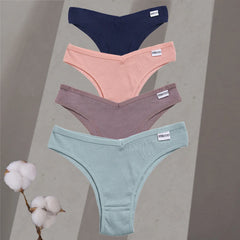 Four pairs of women's underwear in different colors on a gray background with cotton branches.