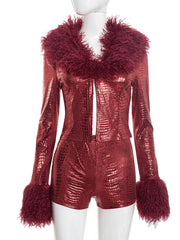 Red metallic jumpsuit with feathered collar and cuffs on a mannequin against a white background