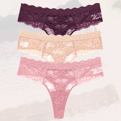 Three pairs of lace underwear in purple, pink, and peach on a textured white background.