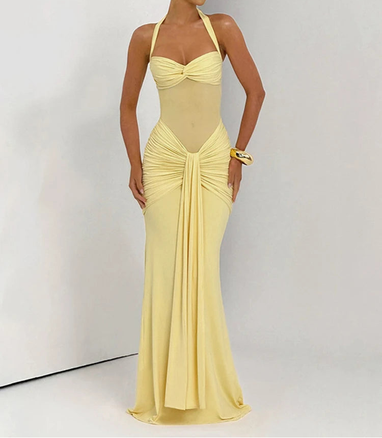 Woman wearing a yellow evening gown against a white background