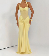 Woman wearing a yellow evening gown against a white background