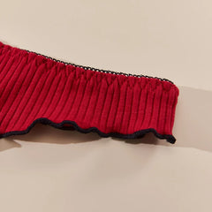 Red ribbed trim with black edge on a beige background