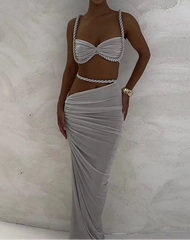 Woman wearing a gray dress with a textured background