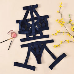 Navy blue lingerie set with accessories on a beige background