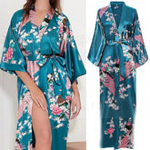 Teal satin robe with floral and bird pattern on a white background