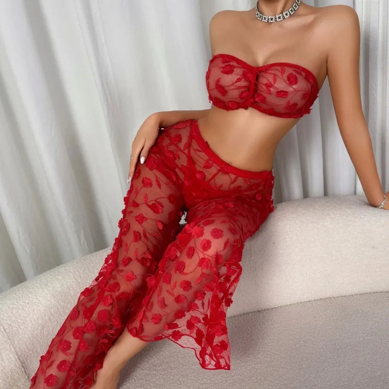 Person wearing a red sheer outfit sitting on a couch with a white curtain background