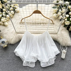 White lace top on a hanger with decorative background