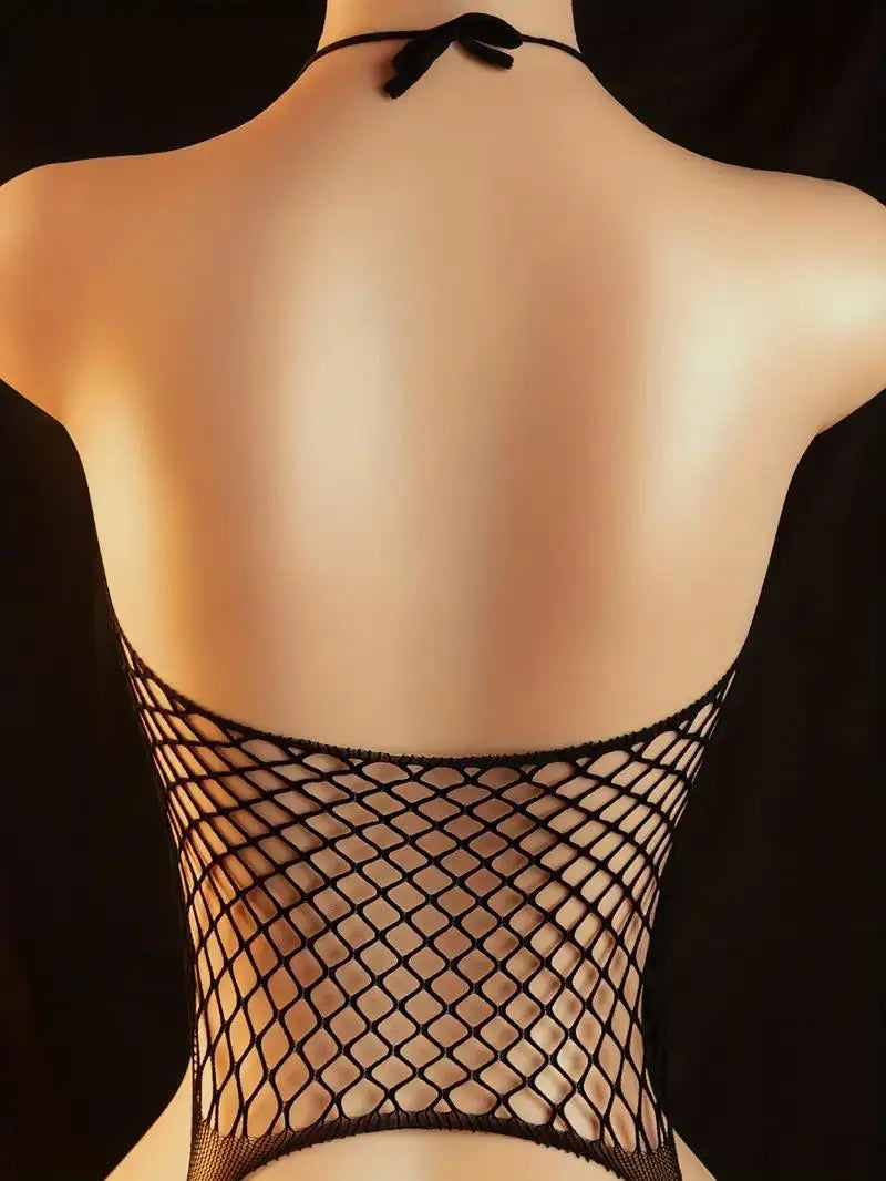 Black fishnet top worn by a model against a dark background