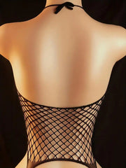 Black fishnet top worn by a model against a dark background