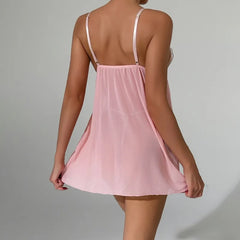 Pink slip dress with thin straps on a gray background