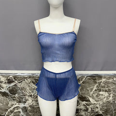 Mannequin wearing a blue sheer top and shorts set against a gray background.