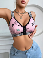 Pink bra with butterfly design worn by a person against a neutral background