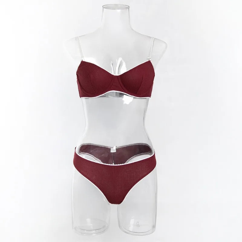 Maroon bikini set on a clear mannequin against a white background
