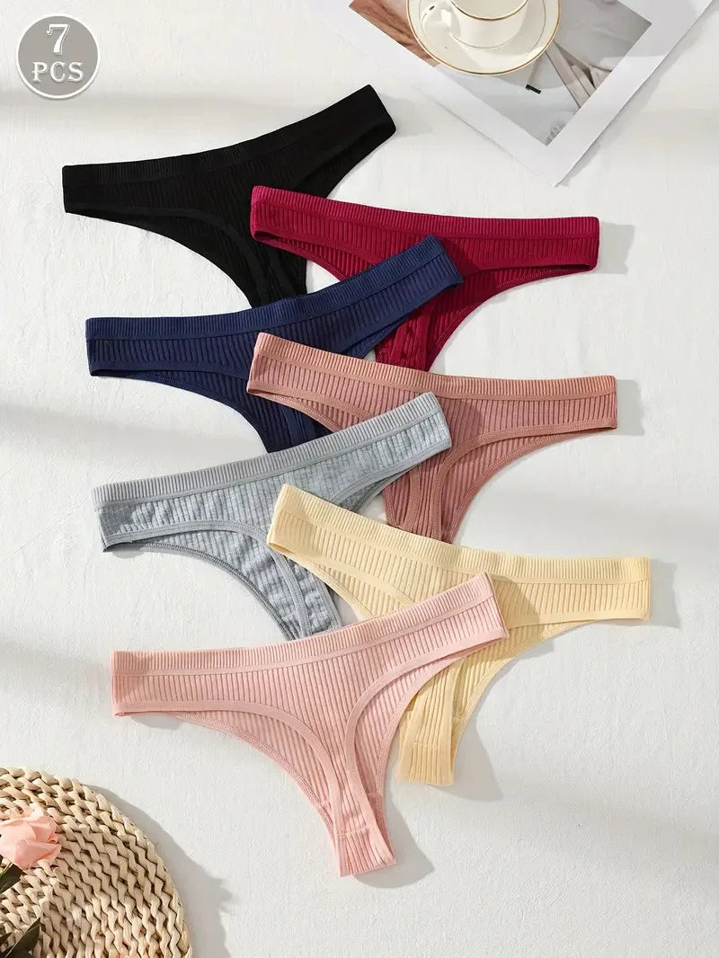 Set of seven pairs of women's underwear in various colors on a white background.