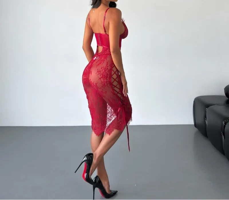 Woman wearing a red lace dress in a minimalistic room.