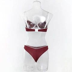 Mannequin wearing a red and white lingerie set on a white background