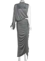 Gray draped dress on a mannequin against a white background