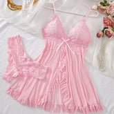 Pink lace nightgown with matching bralette on a white background with flowers and pearls.