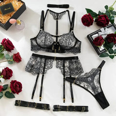 Black lace lingerie set with roses and gift boxes on a white background